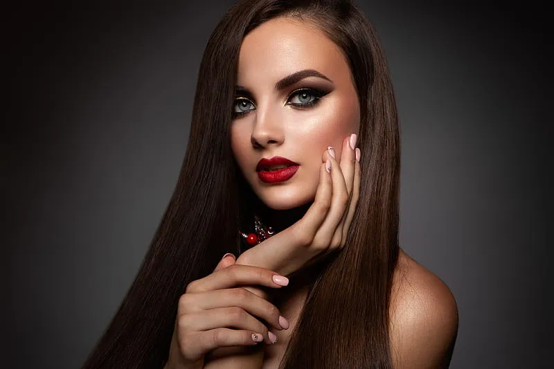 a woman with long brown hair and red lipstick